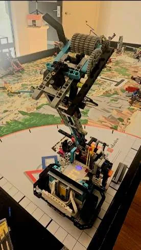 Photograph of attachment one mounted on the robot above the competition mat