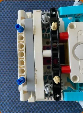 Close up photograph of a LEGO gearbox unit built to carry a robot attachment
